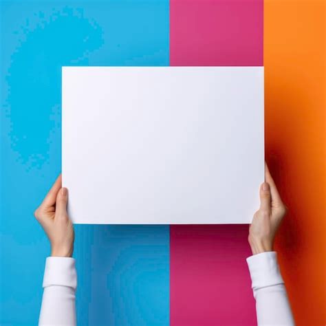 Premium Ai Image Hands Holding An Empty White Board On A Colorful