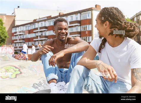 Two Friends Laughing And Chatting Outdoors Stock Photo Alamy