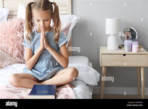 Cute Little Girl Praying In Bedroom Stock Photo Alamy