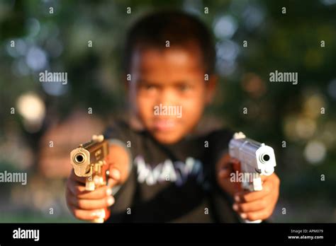 Cambodian Boy Pointing Guns At Camera Stock Photo Alamy