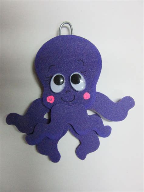 An Octopus Keychain With Googly Eyes On It S Face Is Hanging From A Hook