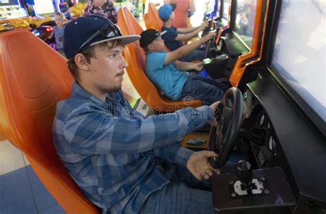Teenagers Boy Plays on the Gaming Car Simulator in the Club Stock Image ...