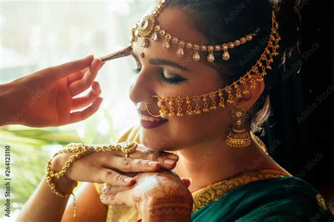 Portrait Indian Beautiful Female In Golden Rich Jewelery Tradition