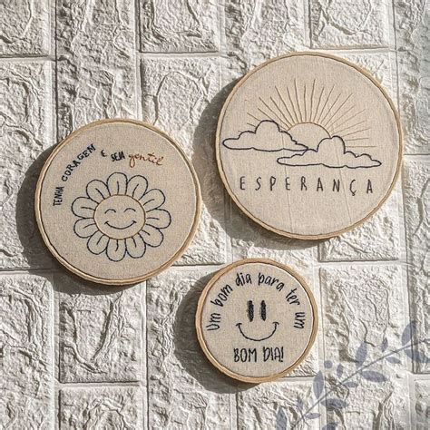 Three Embroidered Coasters Sitting On Top Of A White Tile Floor Next To