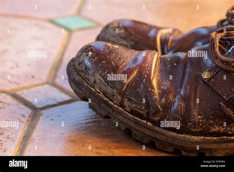 Muddy Boots On Tiled Floor Stock Photo Alamy