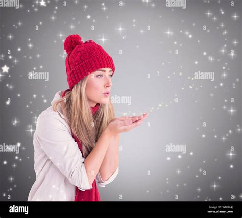 Happy Blonde Blowing Over Hands Against Grey Vignette Stock Photo Alamy