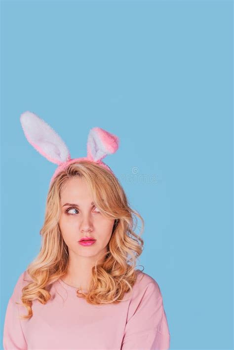 Young Woman With Bunny Ears Playboy Blonde Looking Up Easter Girl Isolated On Blue Stock Image