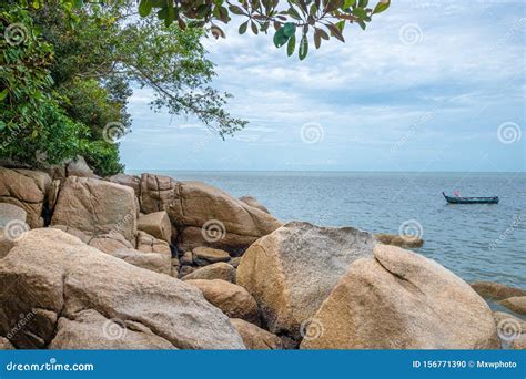 Penang Island Rocks At Beach Next To The Tropical Rain Forest Of Penang