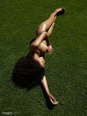 Naughty Ebony Chick Teti Posing Naked On A Grass Photos