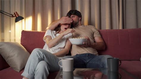 Horror Shocked Man Watching A Scary Movie On Tv At Home And Eating