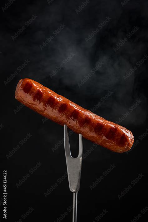 Single tasty roasted meat bockwurst sausage cooked on grill with fried ...