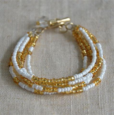 5 Strand White And Gold Seed Bead Toggle Bracelet With Bead Dangle