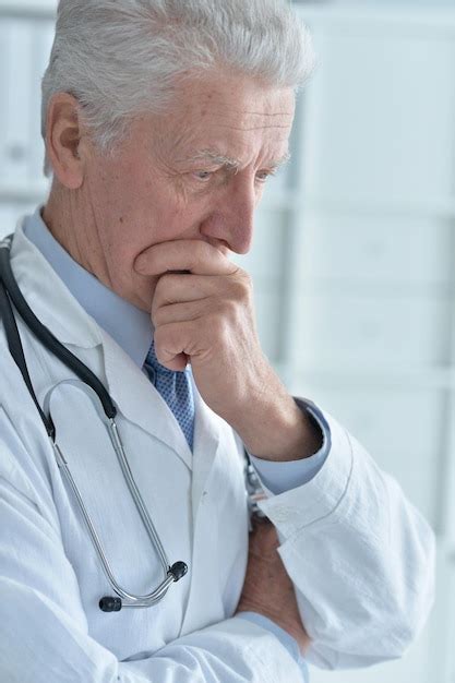 Premium Photo Portrait Of Pensive Senior Male Doctor With Stethoscope