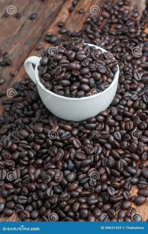 Close Up Shot Of Dark Roasted Coffee Bean In White Ceramic Cup O Stock