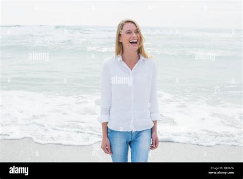 Casual woman laughing at beach Stock Photo - Alamy