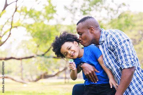 Love Moment Of African American Father Hugging His Son Playing In The