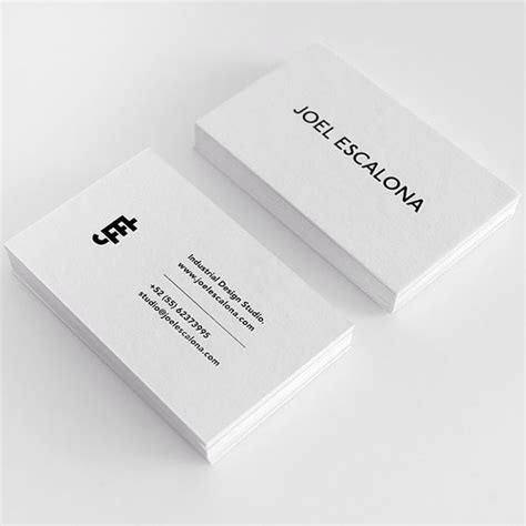 Two White Business Cards Sitting On Top Of Each Other With Black