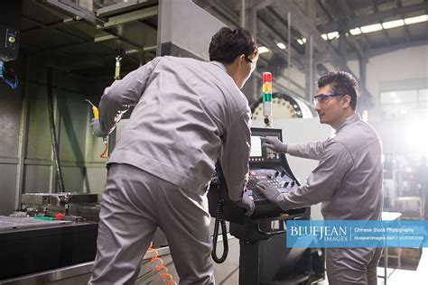 Confident Chinese Engineers Working In The Factory High Res Stock Photo