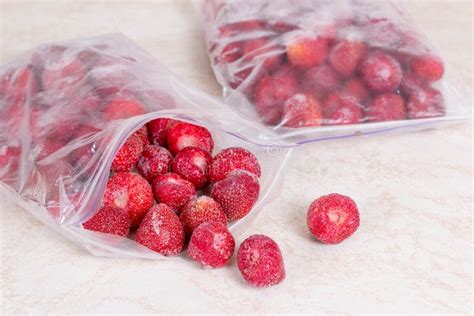 Frozen Strawberries In A Plastic Container In The Freezer Stock Image