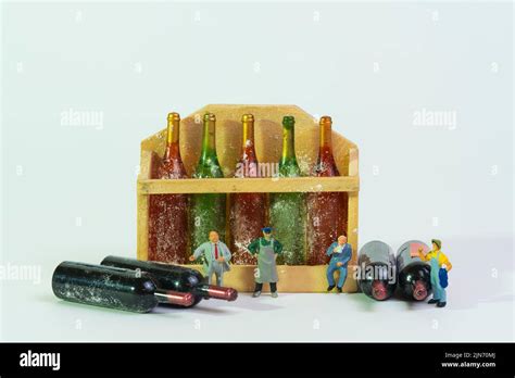 wine connoisseurs stand in front of dusty wine bottles, white ...