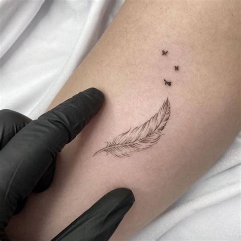 Fine line feather tattoo on the inner forearm | White feather tattoos ...