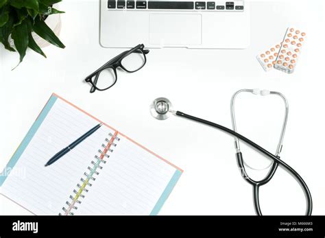 Workplace Of Doctor Stethoscope Notebook Medical Items And Pills On