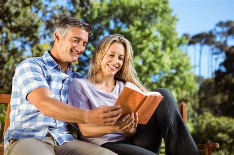 Premium Photo | Couple relaxing in the park on bench