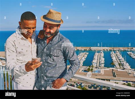 A Gay Couple Using A Mobile Phone Stock Photo Alamy