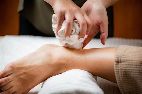 Premium Photo Ankle Joint Cryotherapy Ice Massage Hands Of A Therapist Placing Ice Directly