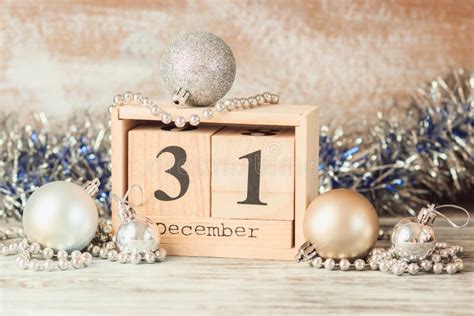 Hand Changing Wooden Calendar With Different New Year Decorations Stock