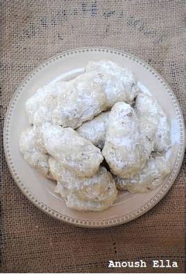 Powdered Sugar Cookies On A Plate With The Words Anous Ella Written Below