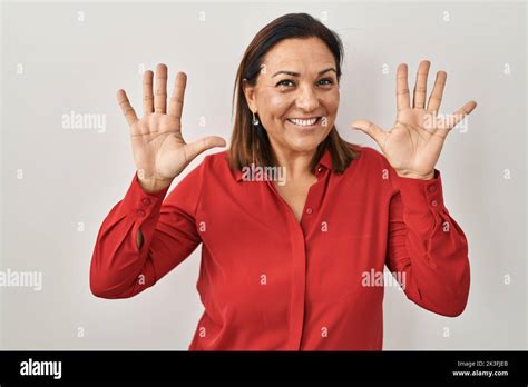 Hispanic Mature Woman Standing Over White Background Showing And