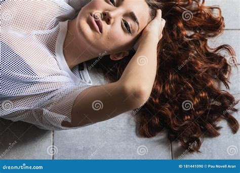 Close Up Sensual Woman Lying On The Floor With Long Tousled Hair Stock