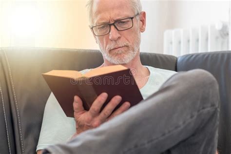Portrait Of Mature Man Reading A Book Light Effect Stock Photo Image