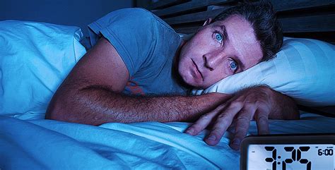 Restless Worried Young Attractive Man Awake At Night Lying On Bed