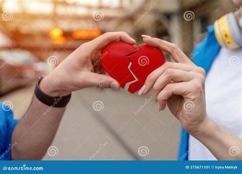 Hands Joining And Holding Red Broken Heart Getting Together After A Breakup Concept Stock Image