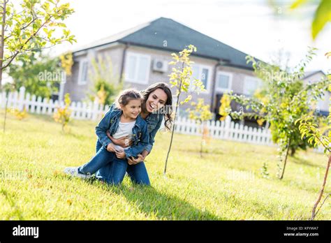 Mother Cuddling Her Little Daughter Stock Photo Alamy