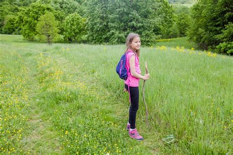 Little Girl Walking On Green Fields At Beautiful Summer Stock Image