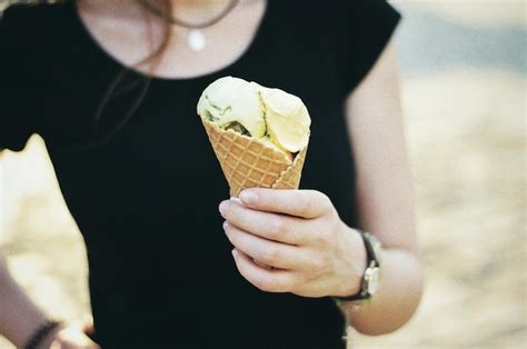 Premium Photo Midsection Of Woman Holding Ice Cream Cone