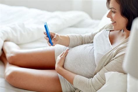 Happy Pregnant Woman Using Smartphone At Home Stock Image Image Of