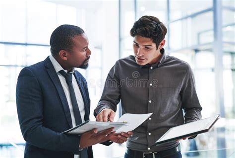 Details Matter Two Young Businessmen Having A Discussion While