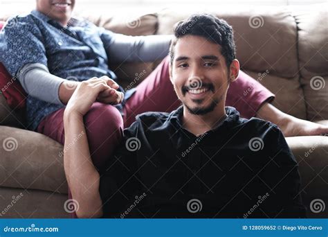 Hispanic Gay Couple Holding Hands On Sofa At Home Stock Photo Image Of Hands Diversity