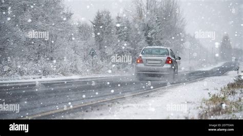 The Car Is Driving On A Winter Road In A Blizzard Stock Photo Alamy