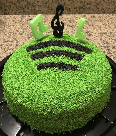 A Cake With Green Frosting And Black Icing That Has A Wifi Symbol On It