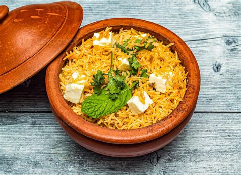 Paneer Biryani Rice Served In Claypot Dish Isolated On Wooden Table Top