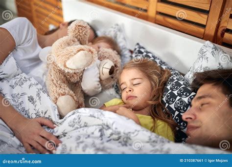 Happy Parents Sleeping Together with Kids Stock Image - Image of ...