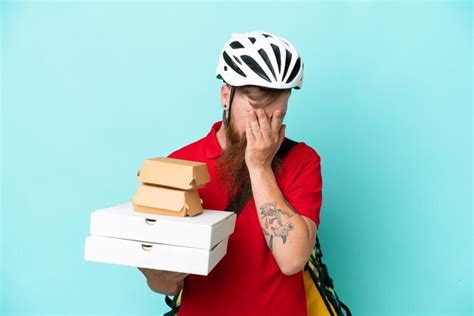 Premium Photo Delivery Man Holding Pizzas And Burgers Isolated On