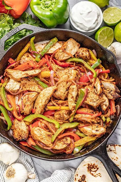 Chicken Fajitas in a cast iron skillet with multi colored bell peppers and onion | Fajita recipe ...