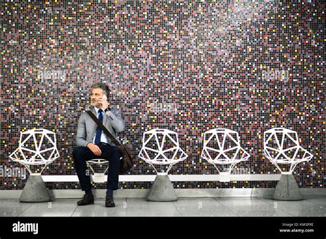 Mature Businessman With Smartphone In A Metro Station Stock Photo Alamy