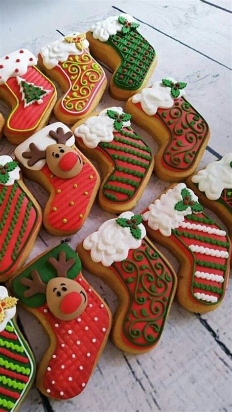 Decorated Christmas Cookies Arranged In Rows On A Table Top With White